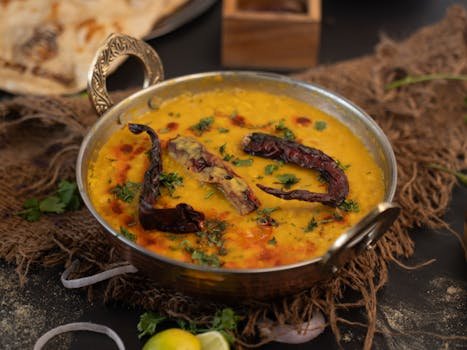 Golden Ayurvedic kadhi soup in a bowl, made with gram flour, yogurt, and warming spices for Kapha balance.