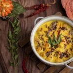 Traditional curry dish served in a bowl, garnished with herbs and spices.