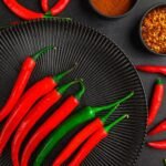 of red chili flakes. The bright red color and spicy ingredients visually represent heat and intensity, symbolizing Pitta‑related vertigo triggers.