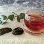 Relaxing herbal tea and stones symbolizing soul and body harmony.