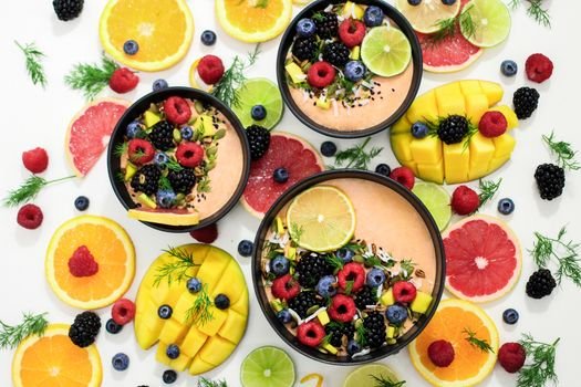 A colorful assortment of fresh fruit bowls featuring mixed berries and citrus for summer detox.