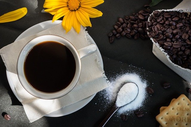 coffee and sugar with a flower flatlay.