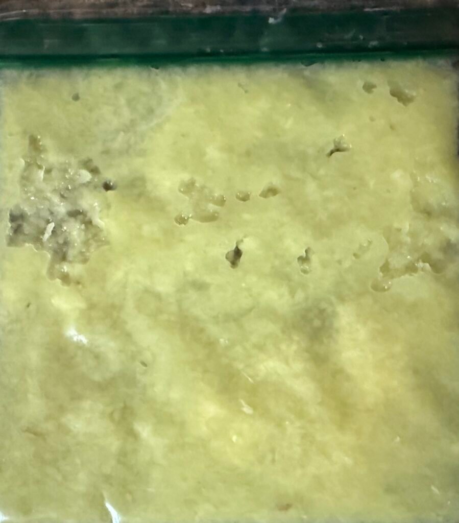 Grated ginger paste thin layered in a freezed bag.