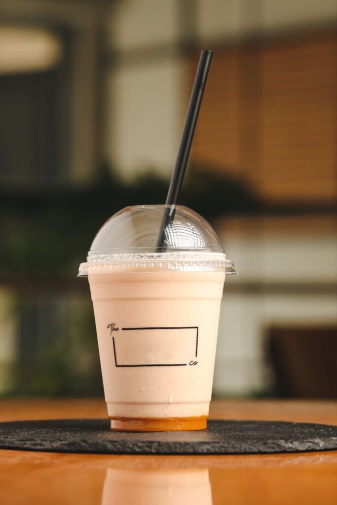 Healthy date sweetened breakfast shake in a travel cup for a busy morning commute."